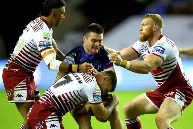 Coach Daryl Powell says Wakefield Trinity have taken confidence from their battling 26-12 defeat at Wigan Warriors last month. Wakefield's Zac Lipowicz is seen being tackled by Bevan French, Luke Thompson and Oliver Partington during that game. Picture by Ed Sykes/SWpix.com.
