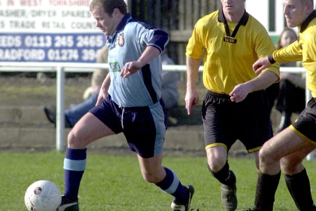 Match action from Farsley Celtic's clash against Flixton in March 2000. Striker Robbie Whellans drives forward.