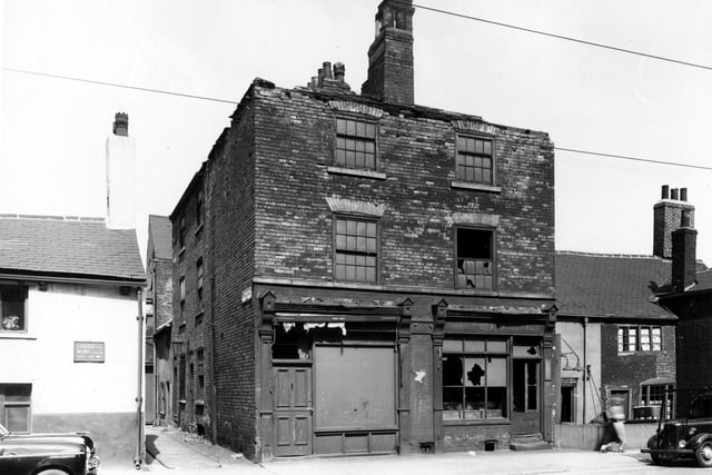 Meadow Lane in July 1956. On the left at number 106 are the premises of Green & Smith Ltd., electrical engineers (Albert Works). This building was once the Spread Eagle Inn. Next right is the entrance to Spread Eagle Yard. The central property in the image houses number 104 and 102. In a directory for 1940 number 104 on the left had been listed as a butcher's shop, proprietor Jas. Ansell Bulmer. Number 102, right, was a chemist's run by Percy Walker Brentnall. Set further back is number 100, in 1940 a house furnishers, business of Fred Plews. Numbers 98 and 96, far right were a confectioner's shop managed by Agnes Brooks. Fred Plews and Agnes Brooks were still listed here in 1955.