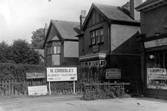 The corner of Shadwell Lane and Harrogate Road in September 1953. On the right is Scarr's Ltd., hardware merchants, at number 6 Harrogate Parade. Signs near the hedge in centre of the photo are for; H. Crossley, plumber and electrician; A. M. Youngs & Son, decorators; A. Lister, upholstery repairs and a 'To Let' sign. Over the hedge is the premises of E. Wells, haulage contractor, a detached house.