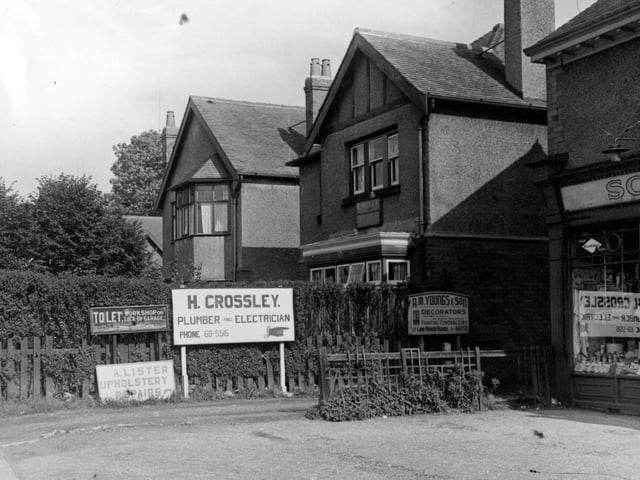 The corner of Shadwell Lane and Harrogate Road in September 1953. On the right is Scarr's Ltd., hardware merchants, at number 6 Harrogate Parade. Signs near the hedge in centre of the photo are for; H. Crossley, plumber and electrician; A. M. Youngs & Son, decorators; A. Lister, upholstery repairs and a 'To Let' sign. Over the hedge is the premises of E. Wells, haulage contractor, a detached house.