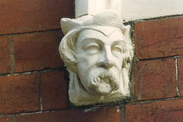 A close up of a carved head at the bottom of archways over front doors on Quarry Street. Pictured in Augiust 1993.