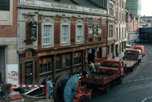 The Scarbrough Hotel on Bishopgate Street. The pub is known locally as 'the Scarbrough taps' and is named after Henry Scarbrough (landlord 1823-47). Railway bridge over Swinegate can be seen in distance on night.