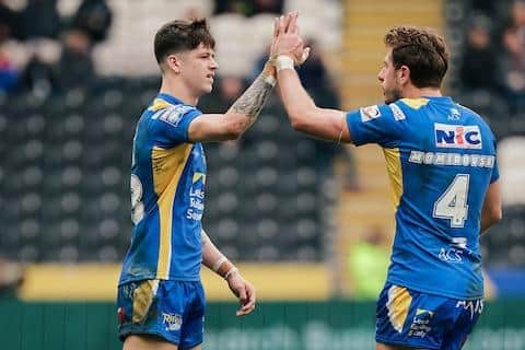 Riley Lumb, left, celebrates with Paul Momirovski after scoring on his Leeds Rhinos debut at Hull FC. Momirovski later limped off with an ankle injury. Picture by Alex Whitehead/SWpix.com.