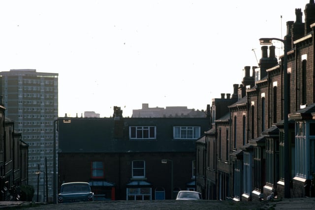 Looking south down Glossop Terrace towards Rider Road in Woodhouse in January 1976.  In the background, left, are the high-rise flats of Holborn Towers.
