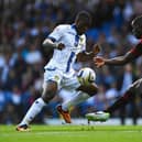 INTERNATIONAL TREBLE: For Dominic Poleon, left, pictured in action for Leeds United in the Championship clash against Queens Park Rangers at Elland Road of August 2013 and battling it out with Nedum Onuoha. Photo by Laurence Griffiths/Getty Images.
