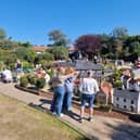 Rachel Hill shows Bondville Model Village to Hot Flash's director and writer