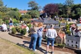 Rachel Hill shows Bondville Model Village to Hot Flash's director and writer