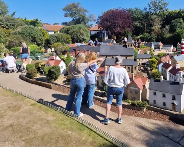 Rachel Hill shows Bondville Model Village to Hot Flash's director and writer