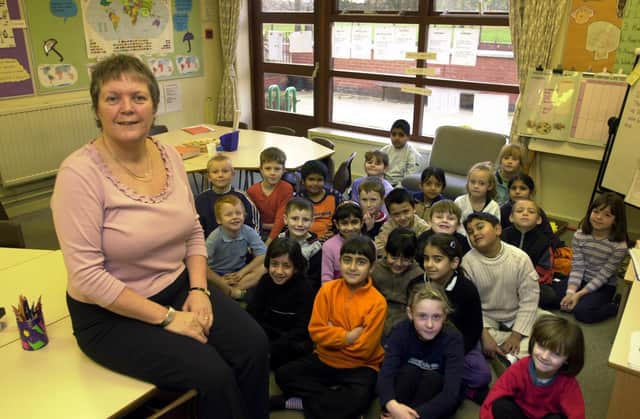 Head teacher Ann Philips with pupils at Cross Flatts Park Primary which was the most improved school in Leeds. Pictured in December 2001.