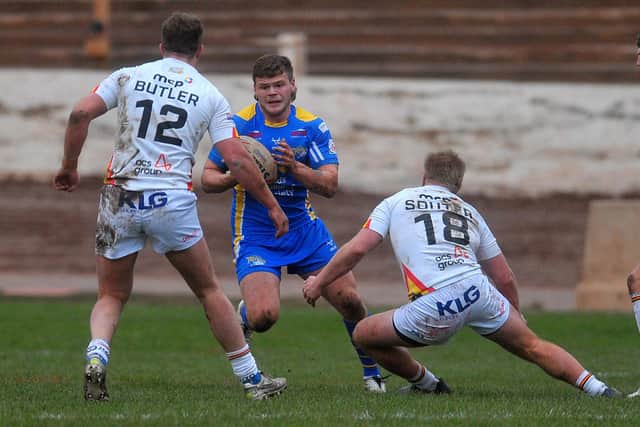 Leeds Rhinos' Tom Nicholson-Watton takes on Bradford Bulls defenders Chester Butler and Mitch Souter. Picture by Steve Riding.