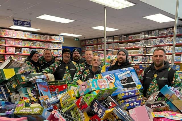 Reese, far right, and his team with some of hundreds of toys they bought from Smyth's Toy Shop