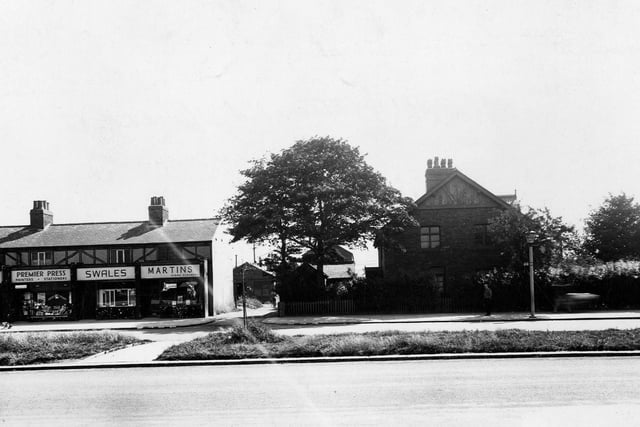 Shops on the east side of Station Road pictured in July 1945. They are Martins Dyers And Cleaners Ltd.; L.W. Swales, tripe dealers and Premier Press, printers.