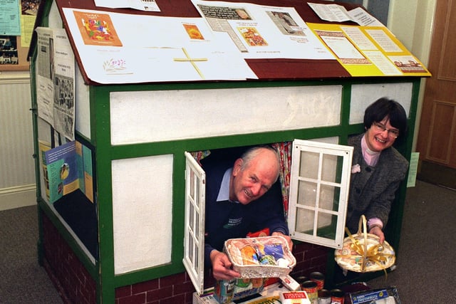September 1997 and a play house is being used as a focus at Bridge United Reformed Church in Otley to collect items for St Georges Crypt in Leeds. In the house are Ron Sweeney, chairman of Christian Outreach Scheme and Rev Mirella Moxon, Minister of Bridge Church.