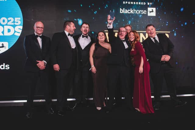 The jubilant First4car team on stage at the Used Car Awards with Tim Smith, head of distribution at category sponsor Black Horse, left, and Mike Brewer, awards night compere.