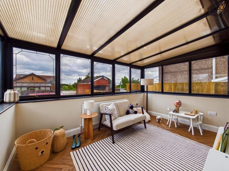 The sun room has a polycarbonate roof and UPVC double glazed windows to the side and front of the property overlooking the front garden and parking area.