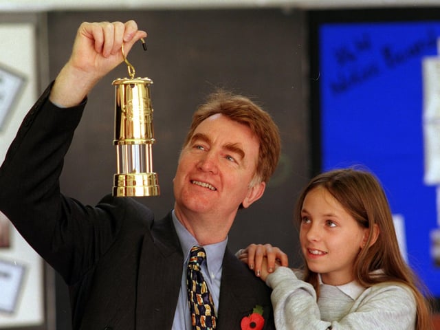 Elmet MP Colin Burgon shows a miners lamp to East Garforth Primary School pupil Rebecca Atkin.