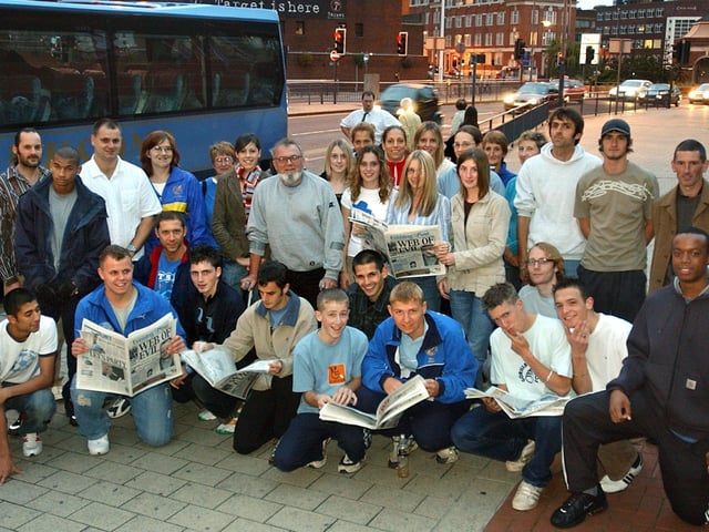 Keeping up with the news in the Yorkshire Evening Post are members of Leeds City Athletic Club, as they prepare to Leave Leeds for Abingdon to take part in the British Athletics League and UK Women's League qualifiers. Centre in the group is John Lunn, team manager, pictured in 2004.