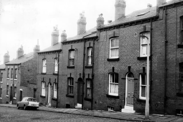 A row of double fronted back-to-back terraced houses with cellars on St Luke's Terrace in June 1973. On the left of number 9 is a shared outside toilet yard.