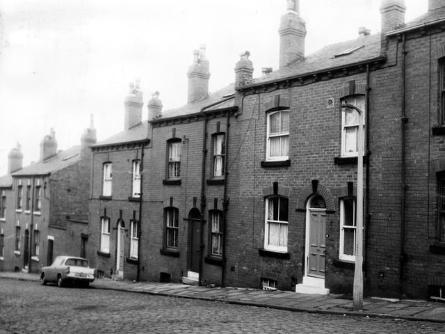 A row of double fronted back-to-back terraced houses with cellars on St Luke's Terrace in June 1973. On the left of number 9 is a shared outside toilet yard.