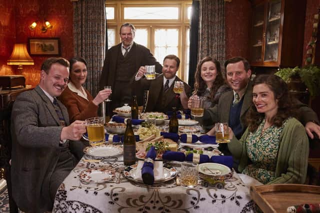 A snap from the All Creatures Great and Small Christmas Special. Pictured: Cast left to right - Callum Woodhouse as Tristan Farnon, Anna Madeley as Mrs Hall, Tony Pitts as Richard Alderson, Samuel West as Siegfried Farnon, Imogen Clawson as Jenny Alderson, Nicholas Ralph as James Herriot and Rachel Shenton as Helen Herriot. Photo: Helen Williams/Channel 5/Playground