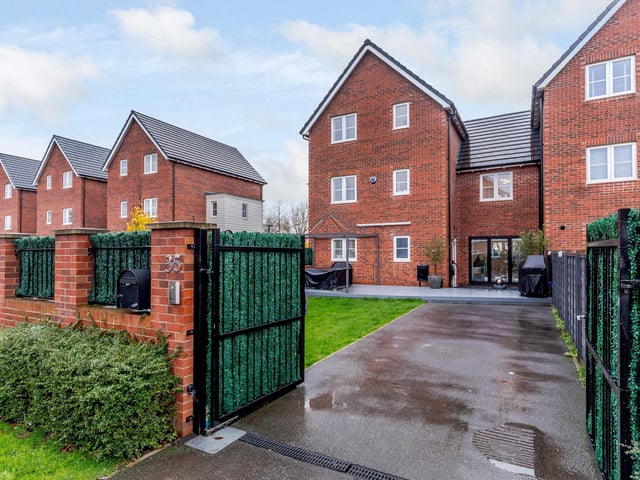 Security gates open to the driveway of the house on this award winning residential development.