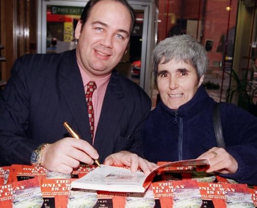 Doncaster Rovers Cheif Executive Ian McMahon signs a copy of his book in 1999.
