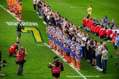 Leeds Rhinos' players - and 80 of Rob Burrow's former teammates - line up on the pitch before the game against Leigh.Rob Burrow honoured in Leeds Rhinos win