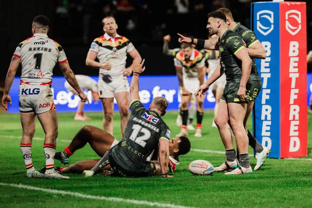 James McDonnell celebrates after scoring in Leeds Rhinos' hard-fought Easter win at Bradford Bulls. Teammate Keenan Palasia is expecting another tough encounter in Sunday's rematch. Picture by Alex Whitehead/SWpix.com.