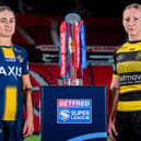 Leeds Rhinos' Mel Howard and Petra Wood, of York Valkyrie, with the Betfred Women's Super League trophy. Picture by Allan McKenzie/SWpix.com.
