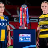 Leeds Rhinos' Mel Howard and Petra Wood, of York Valkyrie, with the Betfred Women's Super League trophy. Picture by Allan McKenzie/SWpix.com.