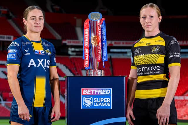 Leeds Rhinos' Mel Howard and Petra Wood, of York Valkyrie, with the Betfred Women's Super League trophy. Picture by Allan McKenzie/SWpix.com.
