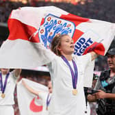LONDON, ENGLAND - JULY 31: Rachel Daly of England celebrates with a flag and their winners medal after the final whistle of the UEFA Women's Euro 2022 final match between England and Germany at Wembley Stadium on July 31, 2022 in London, England. (Photo by Naomi Baker/Getty Images)