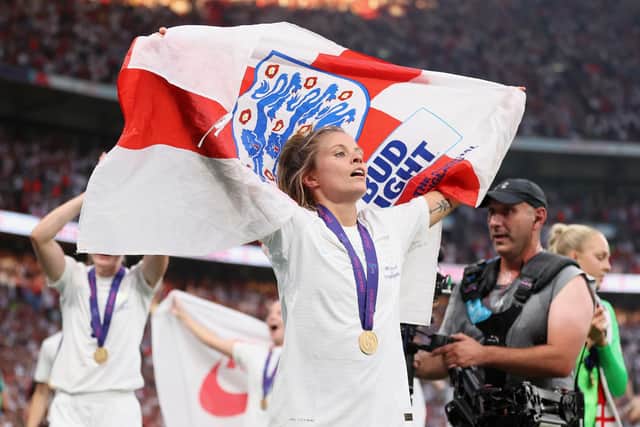 LONDON, ENGLAND - JULY 31: Rachel Daly of England celebrates with a flag and their winners medal after the final whistle of the UEFA Women's Euro 2022 final match between England and Germany at Wembley Stadium on July 31, 2022 in London, England. (Photo by Naomi Baker/Getty Images)