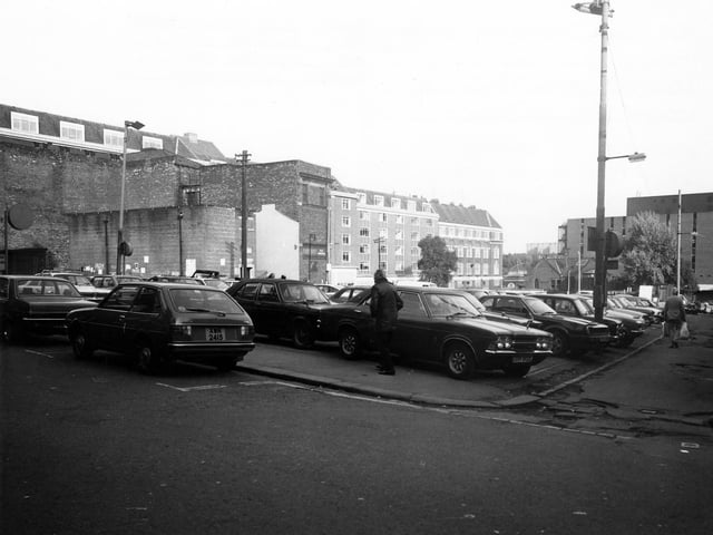 Harewood Street showing the Central Car Park in the foreground. In the background towards the left are an old electricity sub-station and warehouse, and behind these a row of buildings on Union Street which face onto Eastgate and have recently been demolished to make way for the new Victoria Gate development. In the background, right, is Millgarth Police Station which has also recently been demolished. Pictured in January 1980.