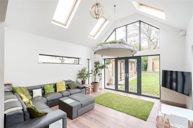 The living room is a bright and airy space, with stunning picture and velux windows allowing the natural light to flood through.
