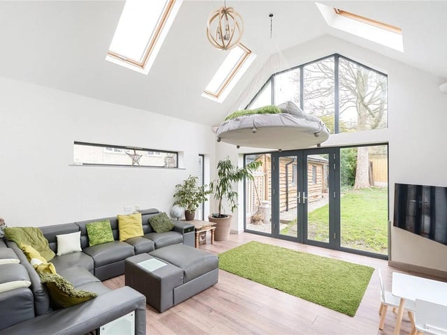 The living room is a bright and airy space, with stunning picture and velux windows allowing the natural light to flood through.