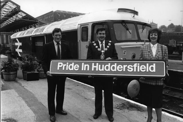 Business and civic leaders took part in naming a diesel locomotive in June 1988 in the hope that it would bring job creating investment to the city.  The chairman of a business organisation, Huddersfield 2000, Nancy Kidd, unveiled the nameplate on the diesel called Pride In Huddersfield. She is seen holding the plate with the Mayor of Kirklees, Coun John Holt, and British Rail's provincial manager, David Wharton-Street.