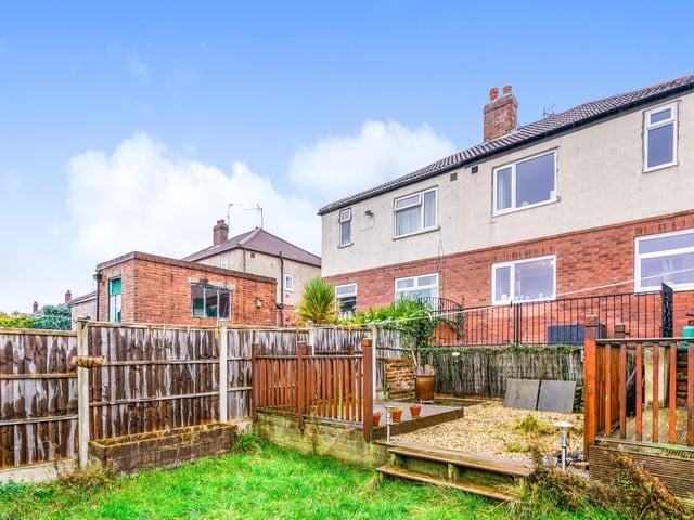 Outside is a functional garage, plus a decking and green area to the foot of the property.
