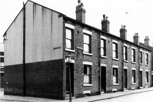 On the left is Balmoral Road with Balmoral Terrace just visible on the far left. On the right are nos. 5 to 11 Balmoral Street, four single fronted back-to-back terraced houses with a yard on the right originally built to house a shared outside toilet. While stone lintels at pavement level show where the basement windows were before road improvements raised the height of the street and blocked them off.