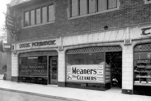 Corner House buildings in July 1937. On the Street Lane side. No. 5 is a branch of Leeds Permanent Building Society. Next, no. 6 Meaners the cleaners. Services advertised in the window are suits, coats, costumes and plain dresses, French cleaned for 2/13 (11 1/2p approx). Also sewing services: picot edging, hem stitching, overlocking and pleating, invisible mending and buttons covered. Just seen on the right is No. 7, Charles Took,