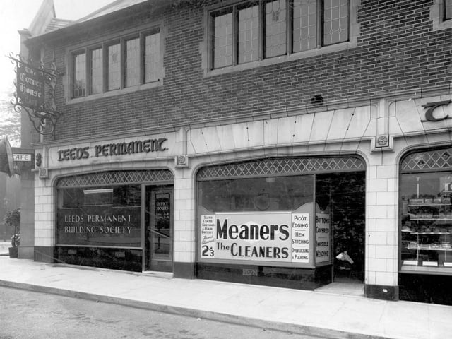 Corner House buildings in July 1937. On the Street Lane side. No. 5 is a branch of Leeds Permanent Building Society. Next, no. 6 Meaners the cleaners. Services advertised in the window are suits, coats, costumes and plain dresses, French cleaned for 2/13 (11 1/2p approx). Also sewing services: picot edging, hem stitching, overlocking and pleating, invisible mending and buttons covered. Just seen on the right is No. 7, Charles Took,