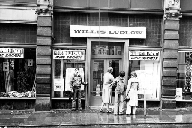 A view of the Willis Ludlow department store on the Ludgate Hill side of Kirkgate Market in January 1979. Shoppers are looking in the windows which advertise 'Huge Savings'.