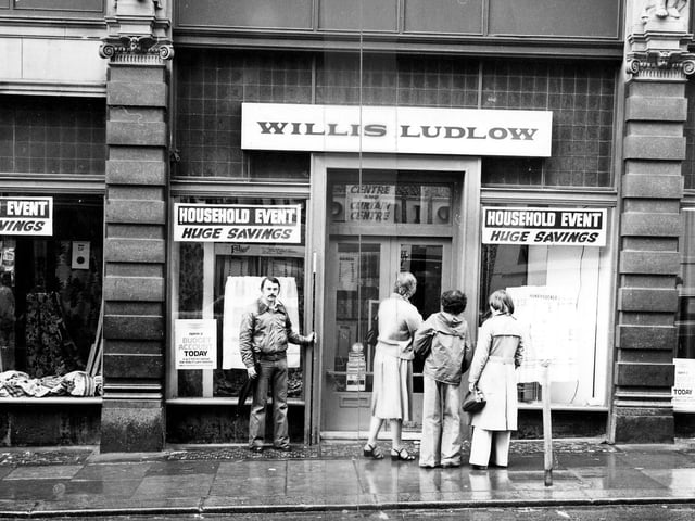 A view of the Willis Ludlow department store on the Ludgate Hill side of Kirkgate Market in January 1979. Shoppers are looking in the windows which advertise 'Huge Savings'.