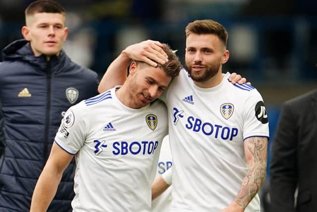 Leeds United's Northern Irish midfielder Stuart Dallas (R) and Leeds United's Swiss defender Gaetano Berardi (L) on the pitch after the English Premier League football match between Leeds United and West Bromwich Albion at Elland Road (Photo by JON SUPER/POOL/AFP via Getty Images)