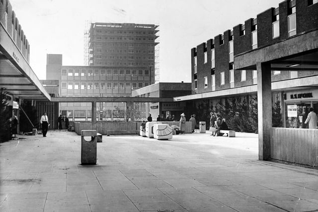 The upper precinct of Seacroft Shopping Centre in October 1965  with a 17 storey block of flats in the background.