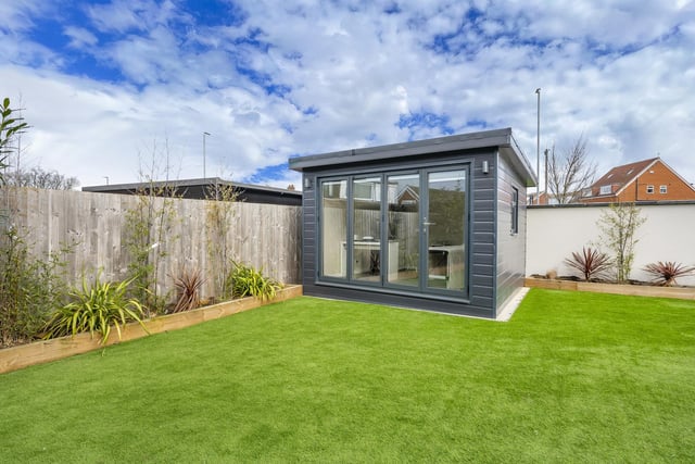 Bi-folding doors downstairs open onto a landscaped garden with tiled patio and pergola accompanied by an artificially turfed lawn space, making the outdoor easy to maintain.