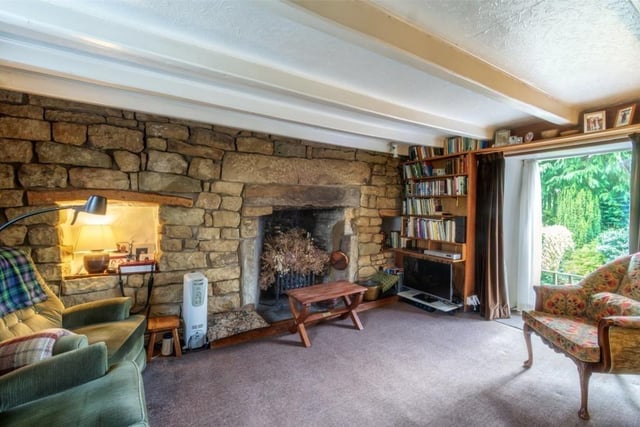 Open stonework to this feature wall with a lovely open fireplace in this sitting room.