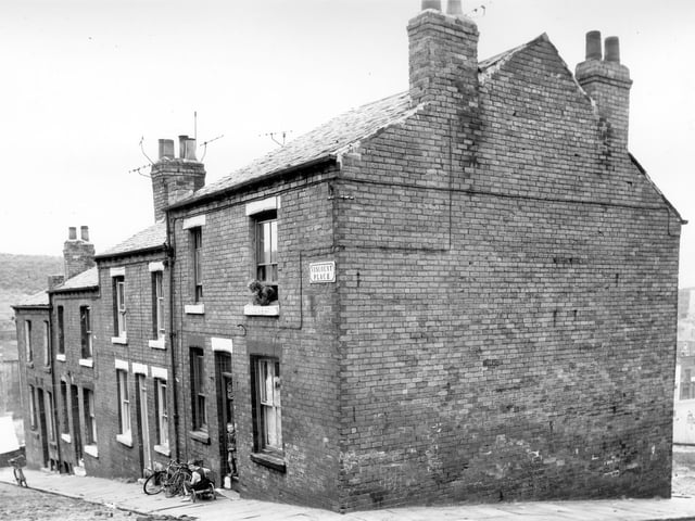 A boy sits on a homemade 'bogie', a kind of go-cart usually constructed of pram wheels and timber on Viscount Place in the direction of Sugarwell Hill. Pictured in August 1965.