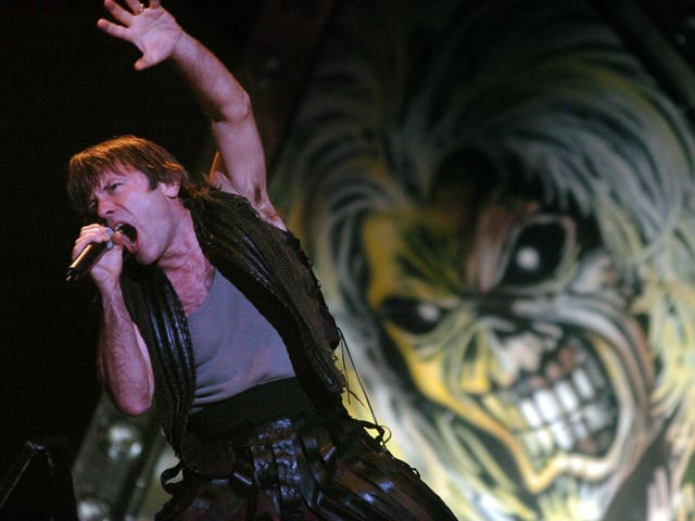 Iron Maiden lead vocalist Bruce Dickinson on stage in full flow in 2005